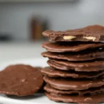 Milk chocolate-covered potato chips on a white plate