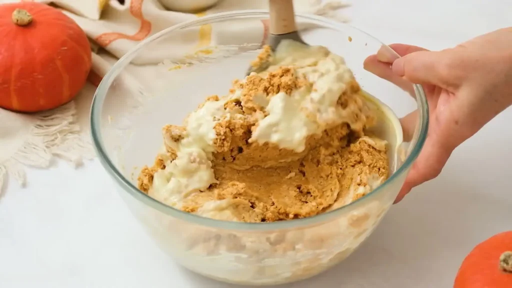 Mixing the ingredients for No-Bake Pumpkin Cheesecake Balls in a glass bowl